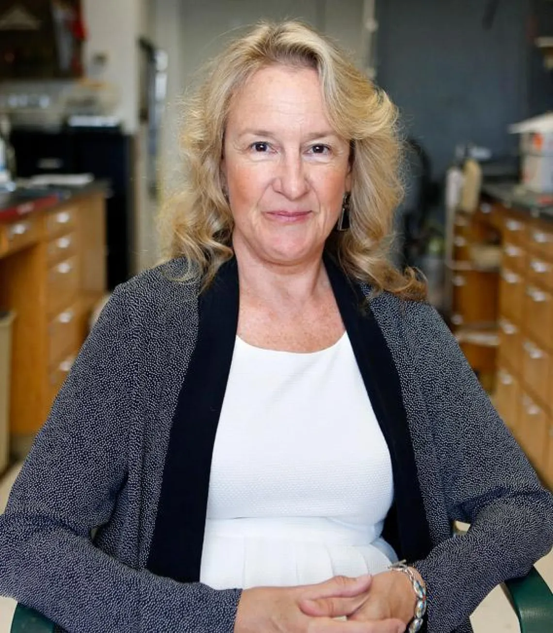 Carol A. Barnes, Ph.D. sitting on a chair